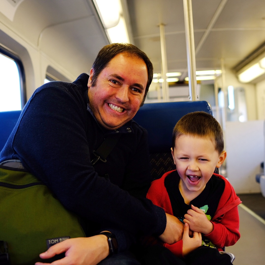 Joel tickles Emmett while riding on the FrontRunner train.