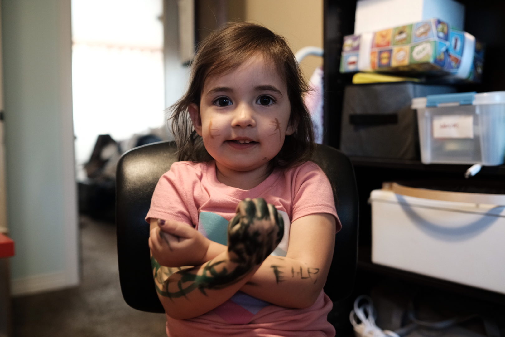 Elle folds her arms that are covered in marker scratches and looks at the camera for me.