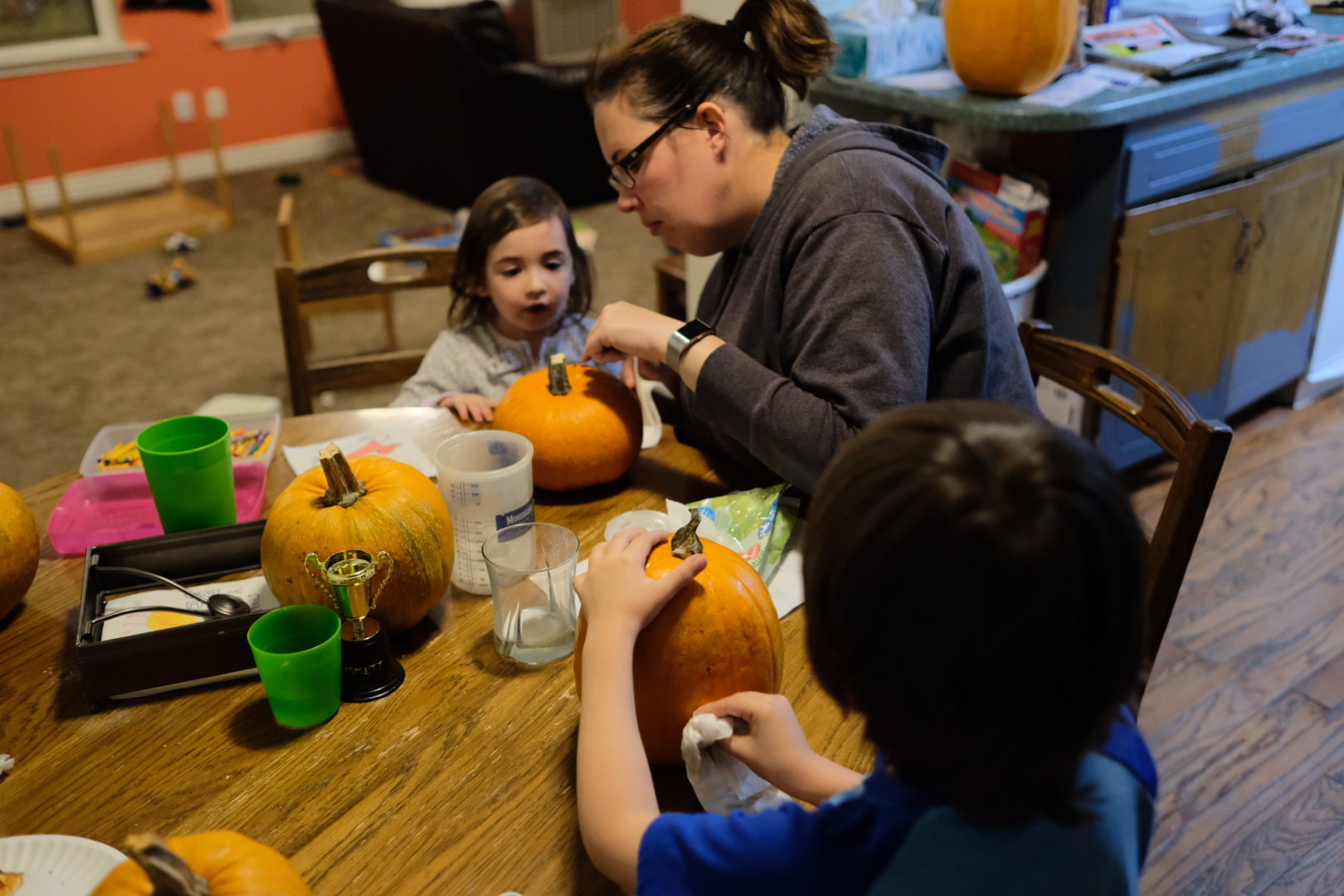 Alicia, Emmett, and Elle are carving pumpkins