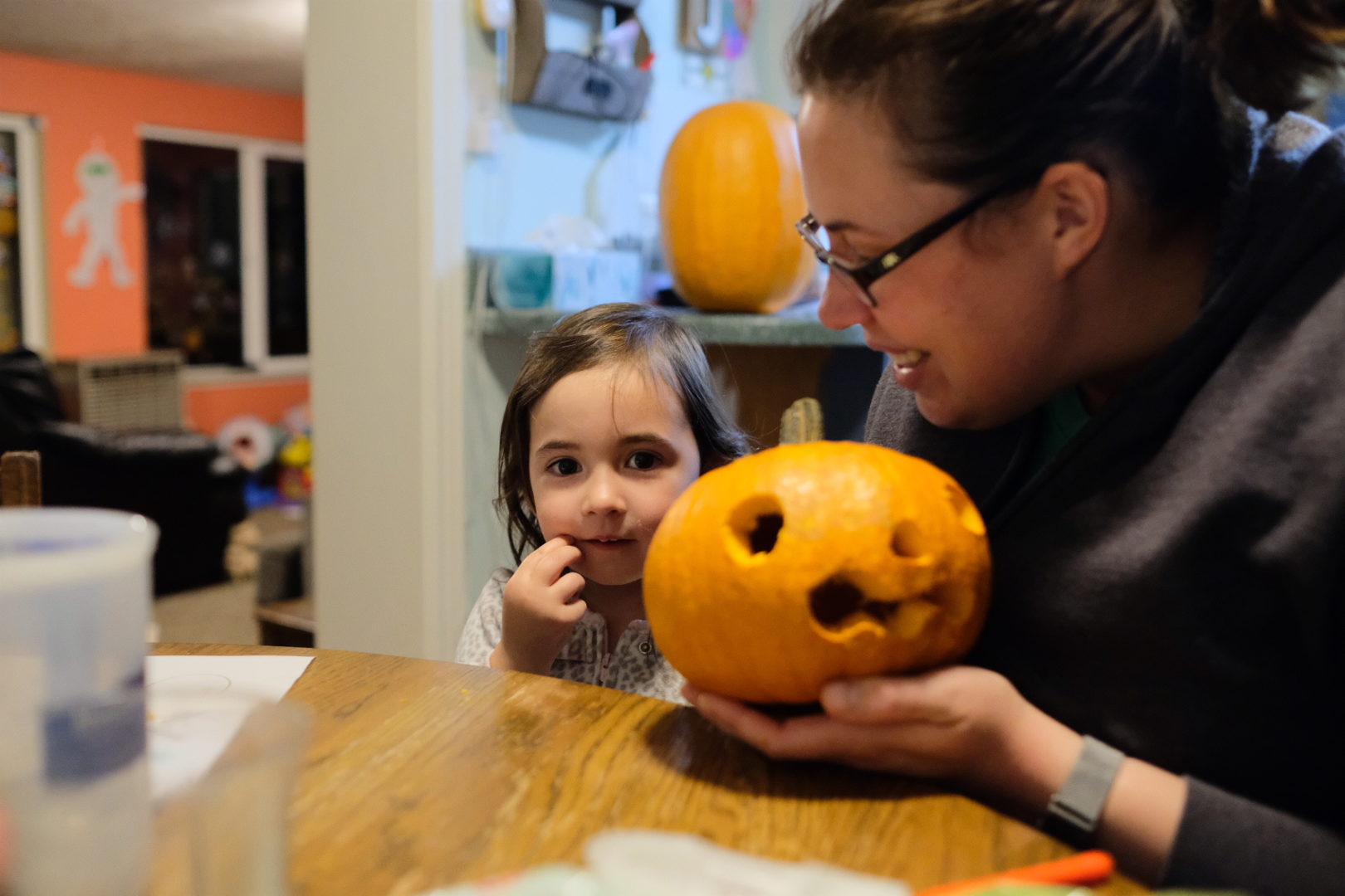Alicia and Elle are looking at their pumpkin.