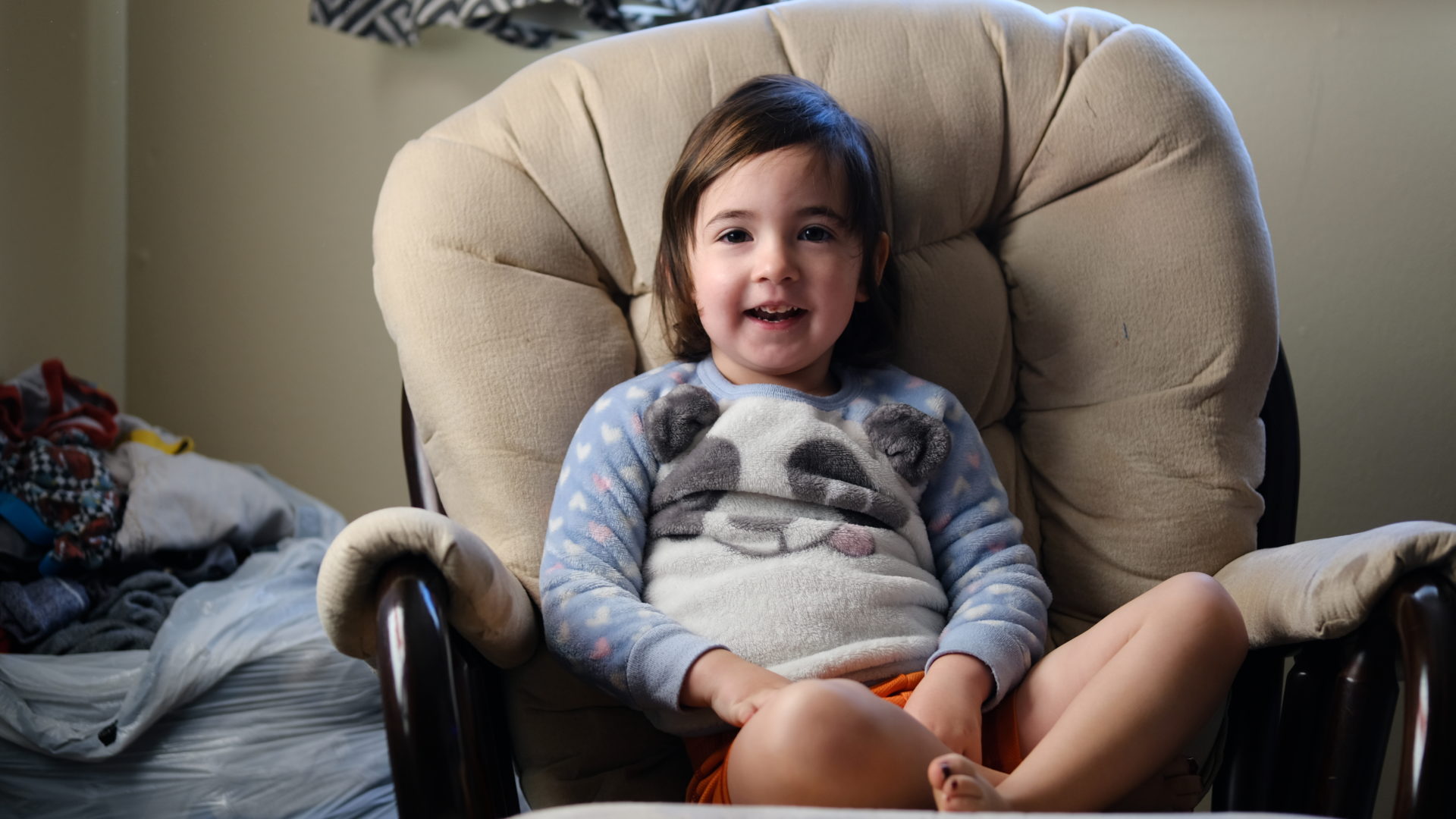 Elle smiles in a rocking chair