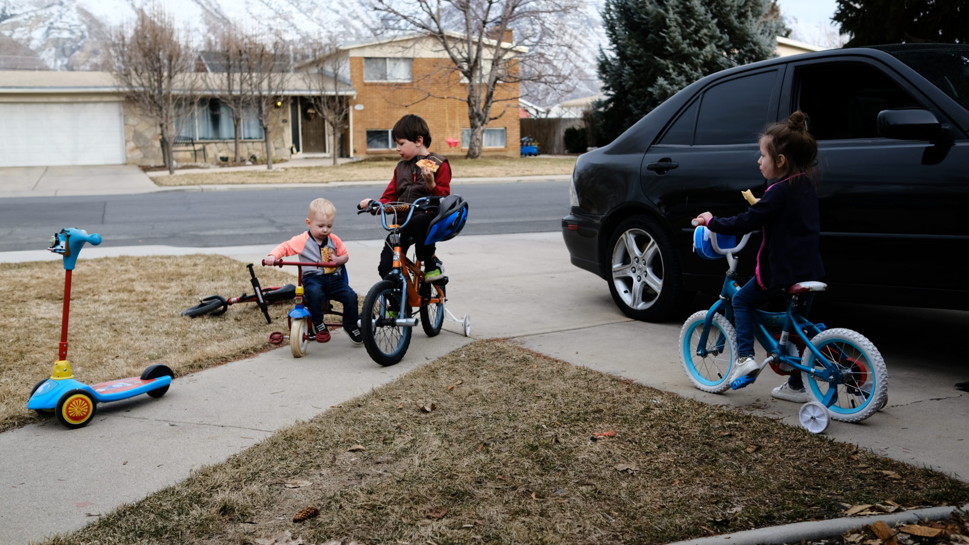 Kids sit on bikes on a warm winter day.